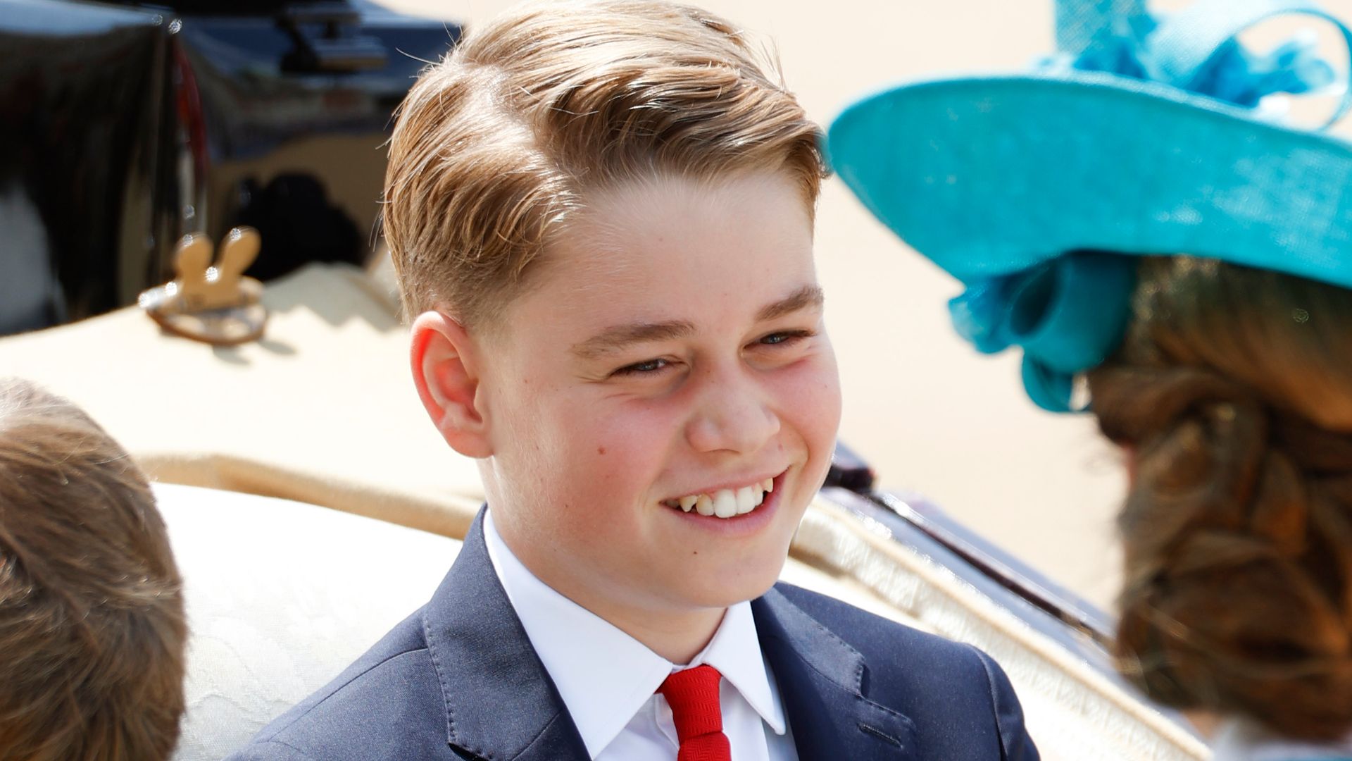 Prince George smiling in carriage