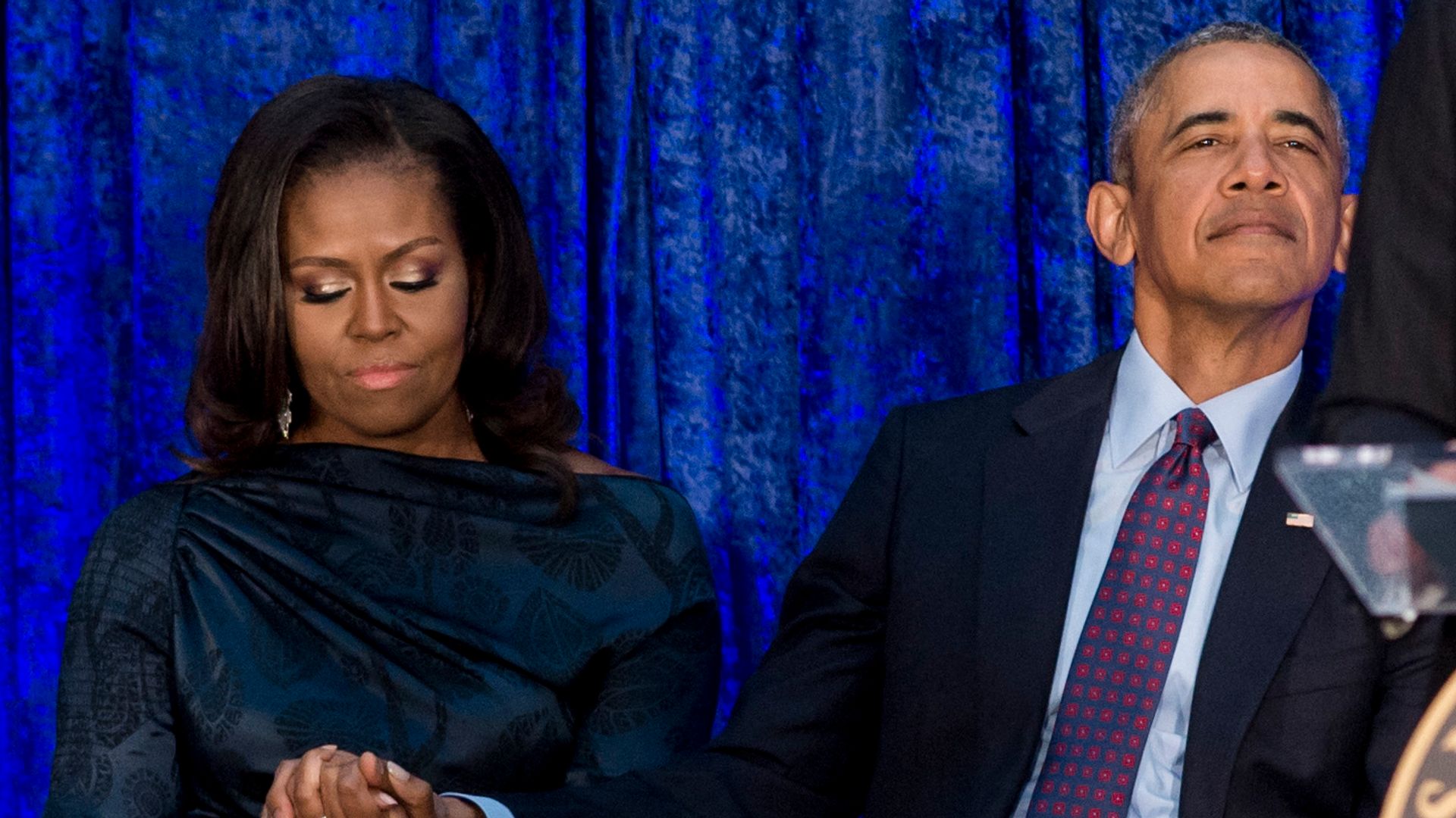 photo of barack obama with hand on michelle obama knee