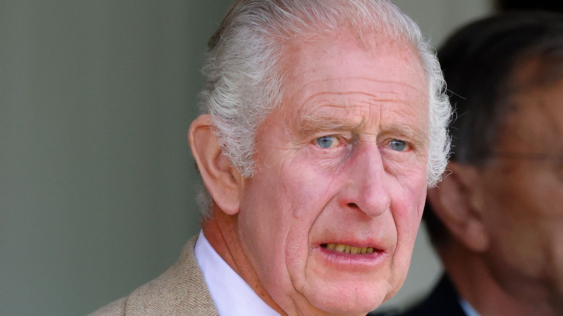 King Charles looking concerned in a nice suit