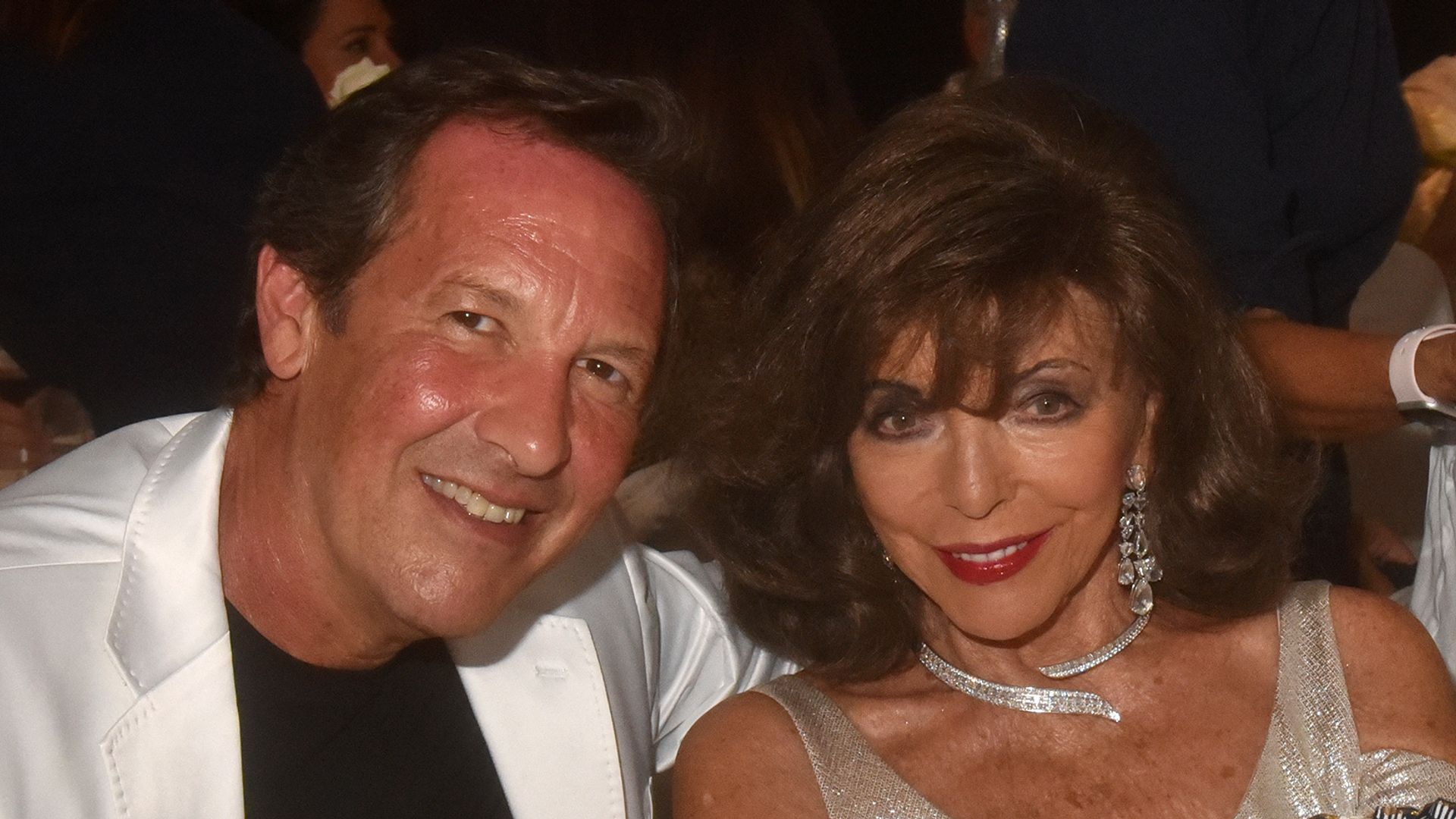 Joan Collins, 91, dazzles in daring silver dress as she joins husband Percy Gibson, 59, at lavish bash | HELLO!