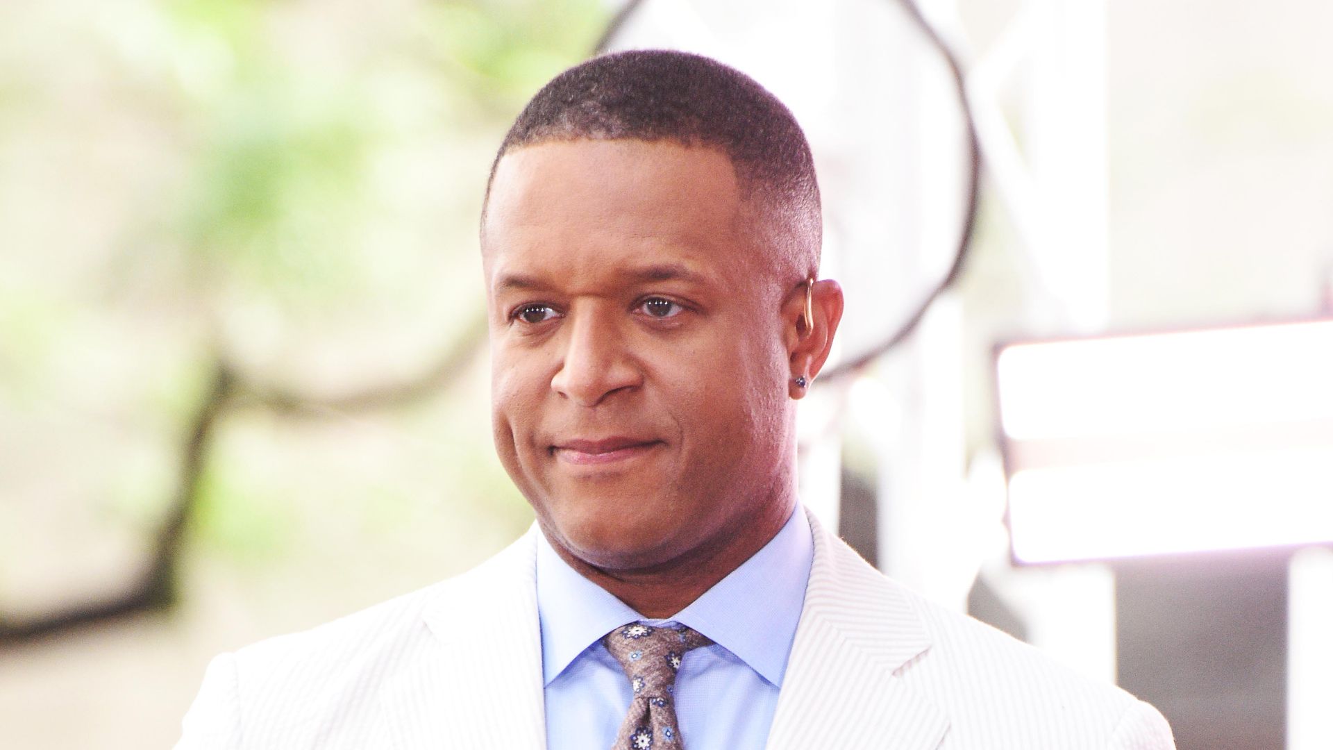 Craig Melvin in blue shirt and white blazer