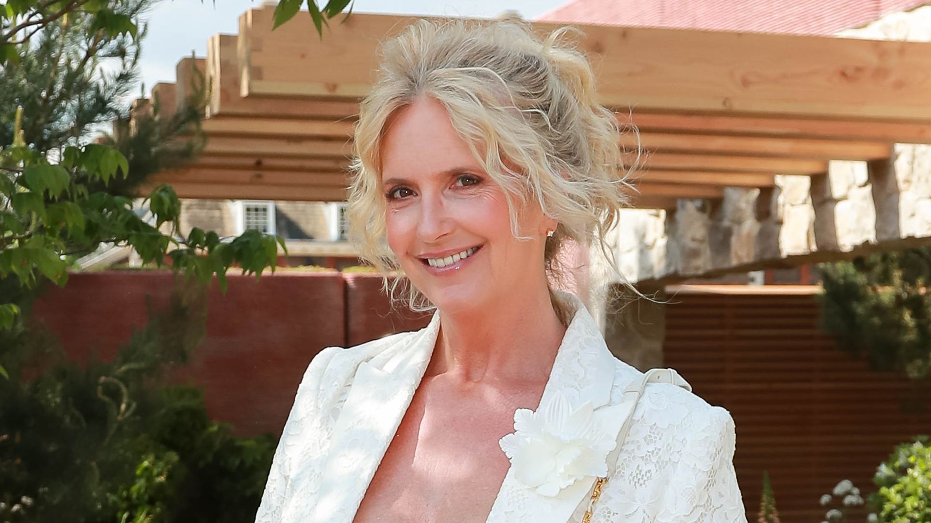 Penny Lancaster posed outside in blue and white floral dress