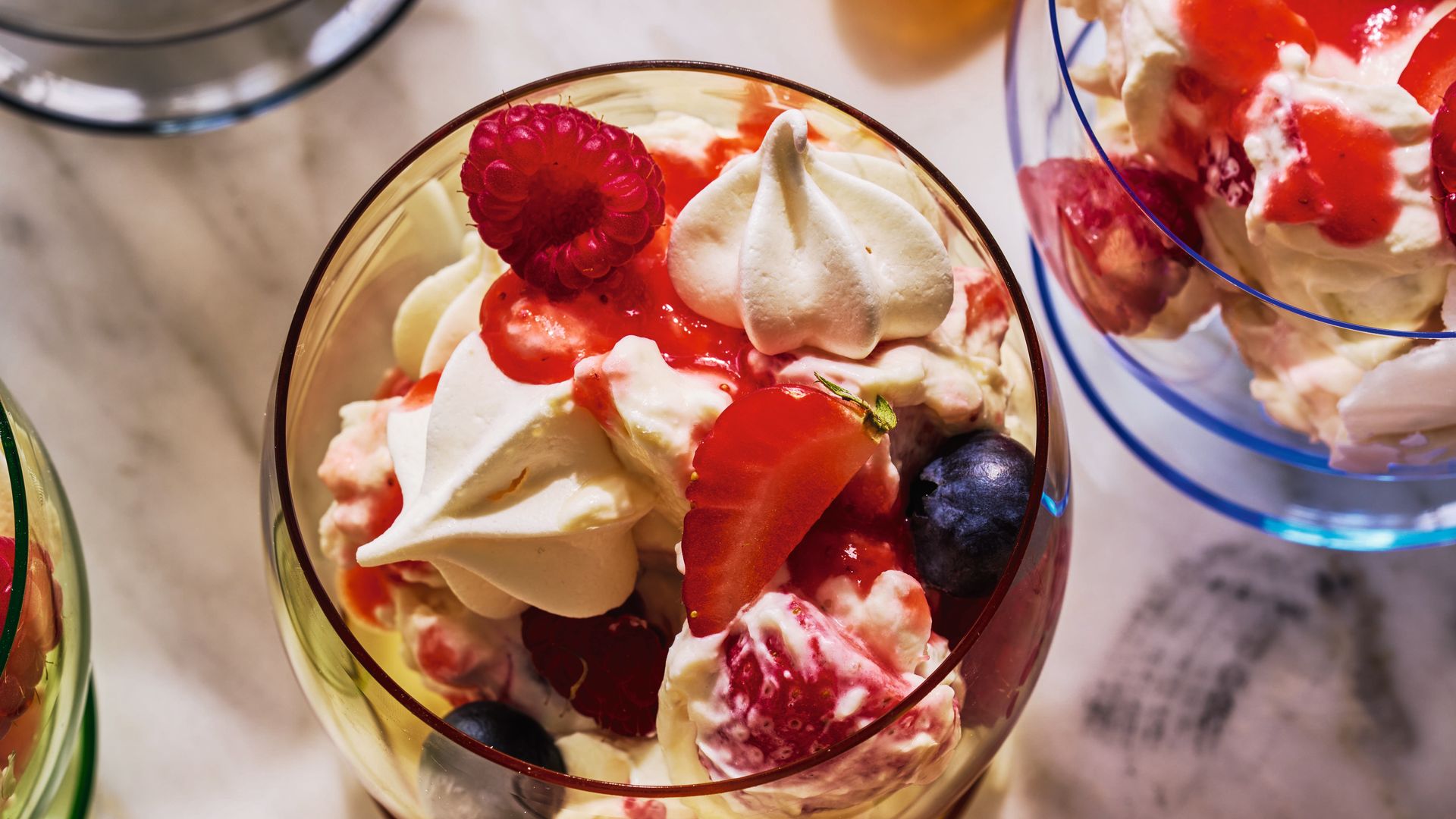 Eton mess decorated with berries and small meringues