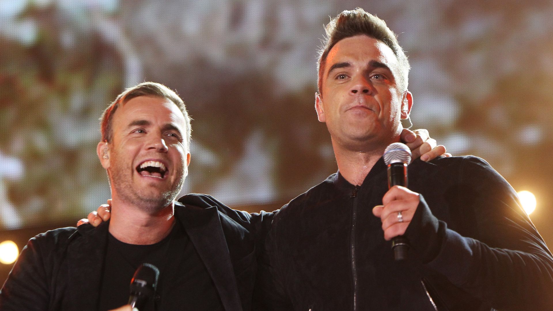 LONDON, ENGLAND - SEPTEMBER 12: L-R Gary Barlow and Robbie Williams perform at the Help The Heroes Concert 2010 held at Twickenham Stadium on September 12, 2010 in London, England. (Photo by Dave J Hogan/Getty Images)