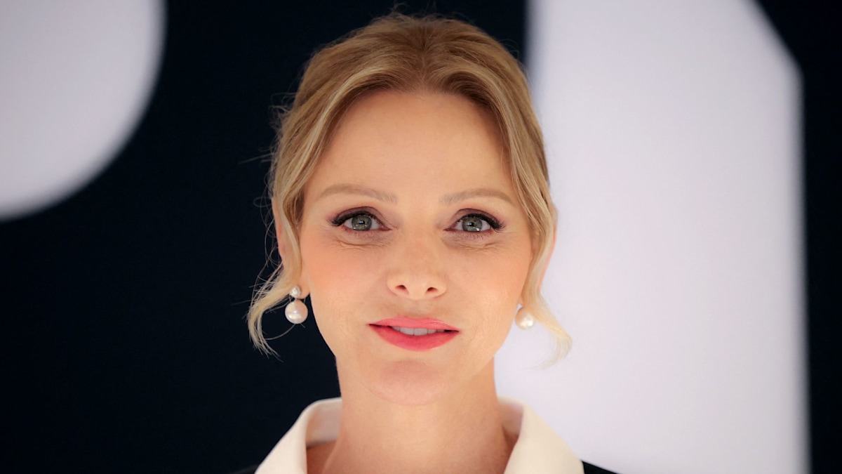 Princess Charlene puts dramatic spin on pinstripes in unusual semi-sheer look