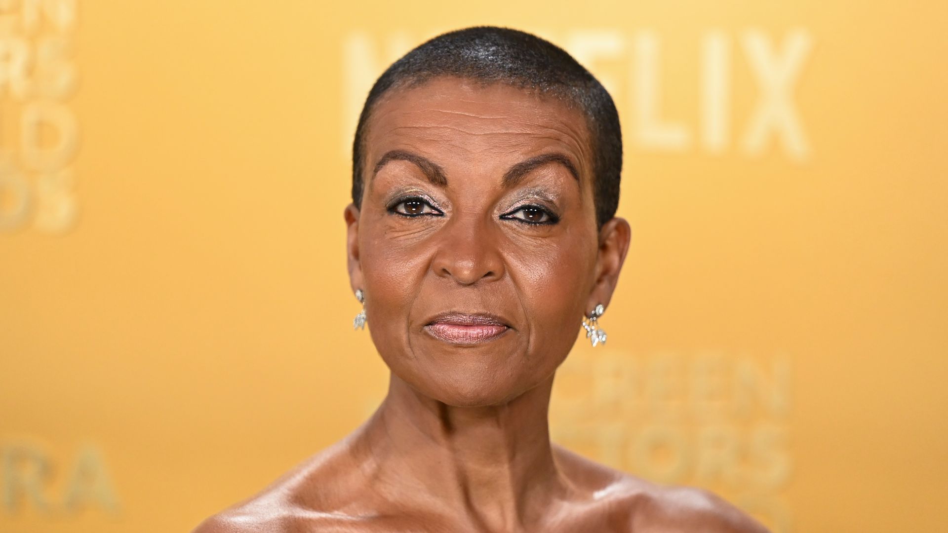 Anjoa Andoh in an off-the-shoulder dress