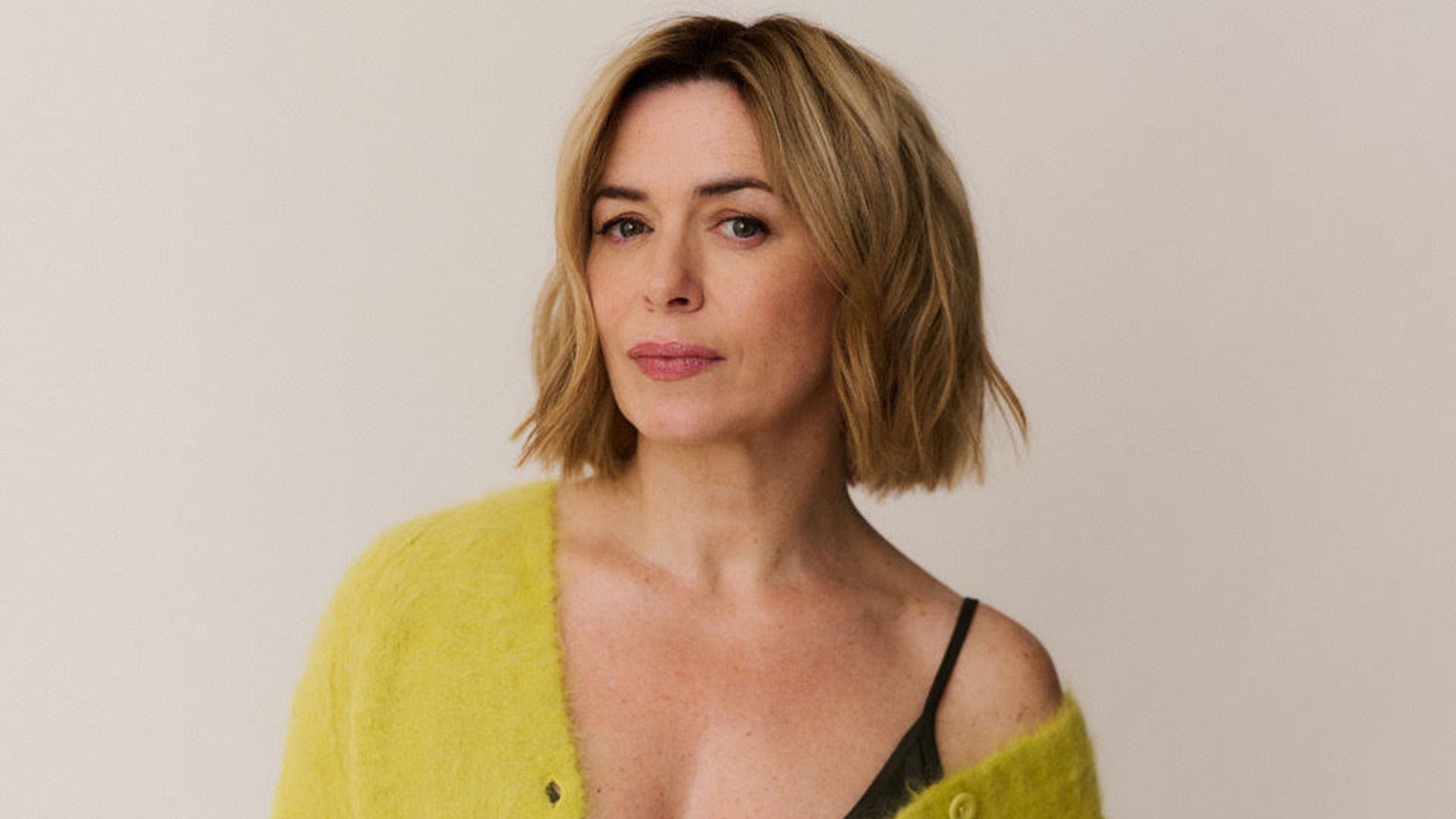 woman in lime green cardigan looking into the camera with her hair cut into a bob 