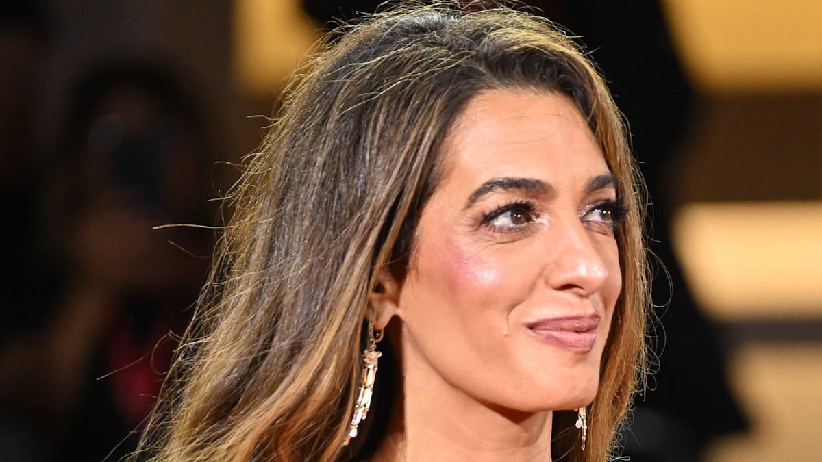 Amal Clooney flies under the radar in ‘refined’ trench with tumbling caramel locks