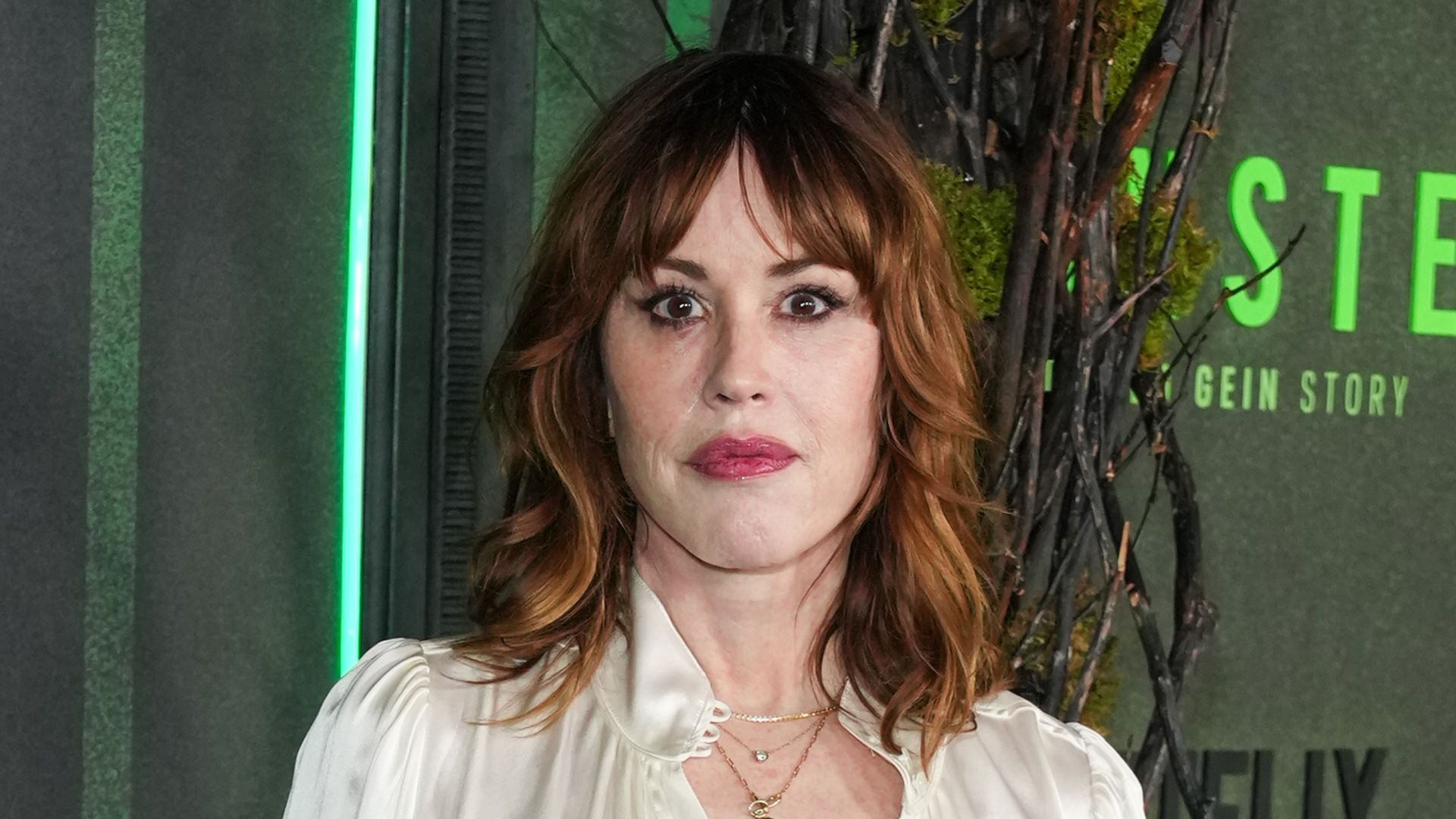 photo of molly ringwald in white blouse and leather skirk