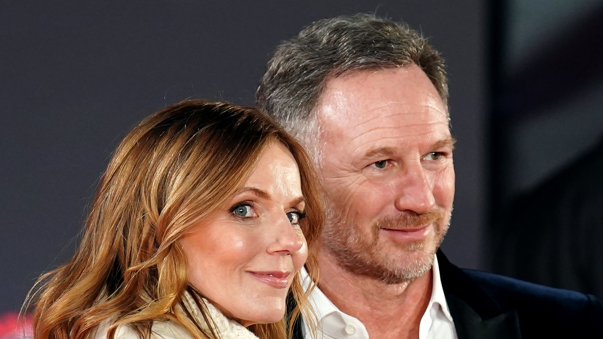 couple smiling on red carpet