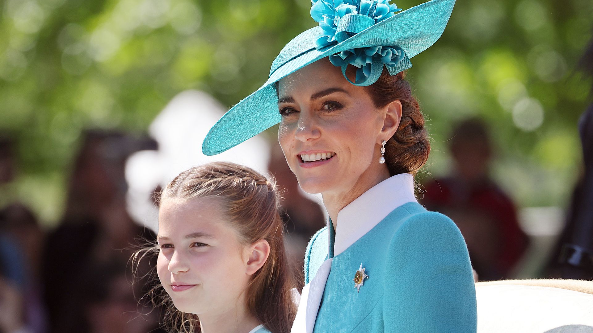 Kate Middleton and Princess Charlotte riding in carriage