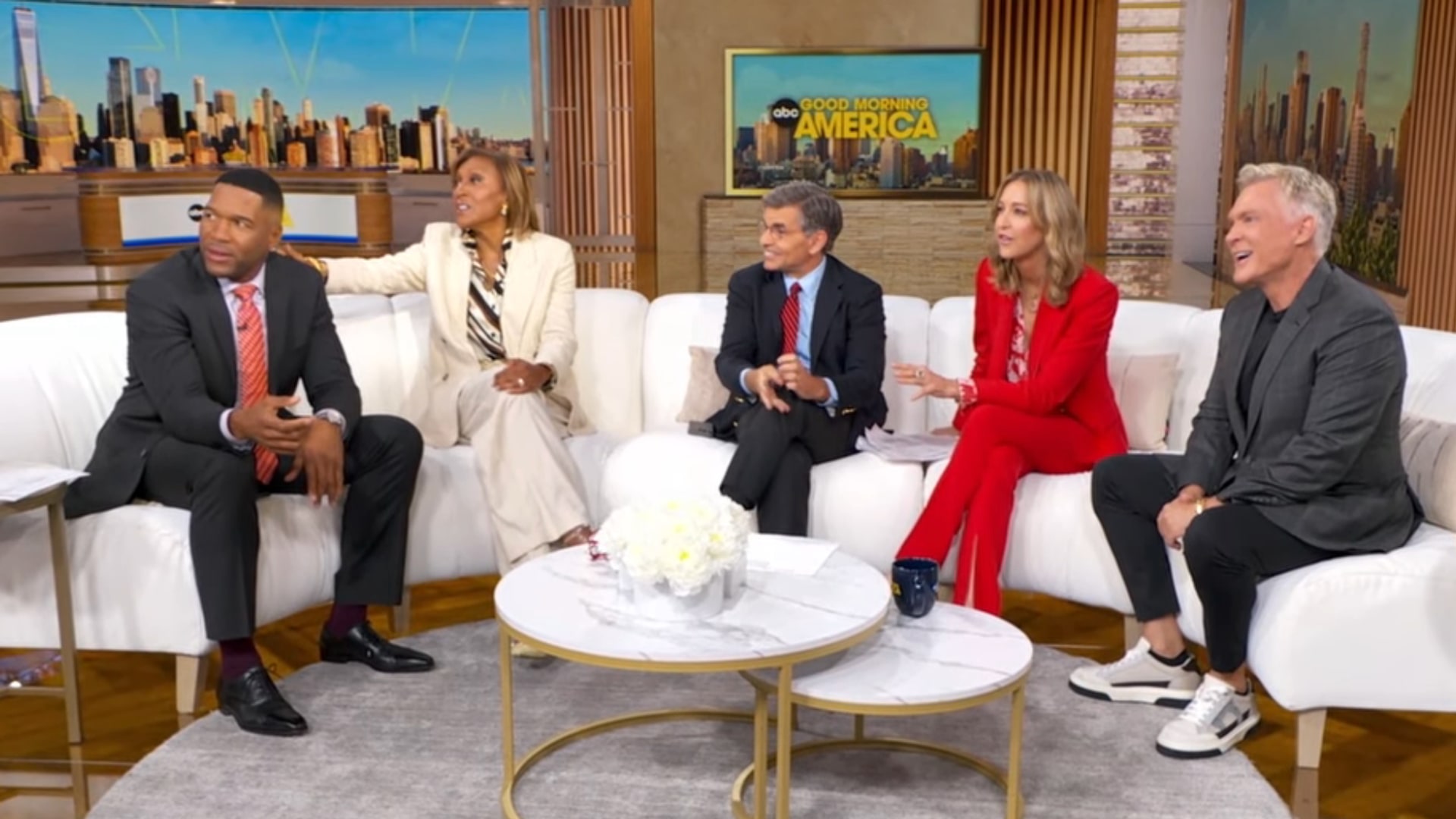 Michael sitting alongside his GMA co-hosts on the show