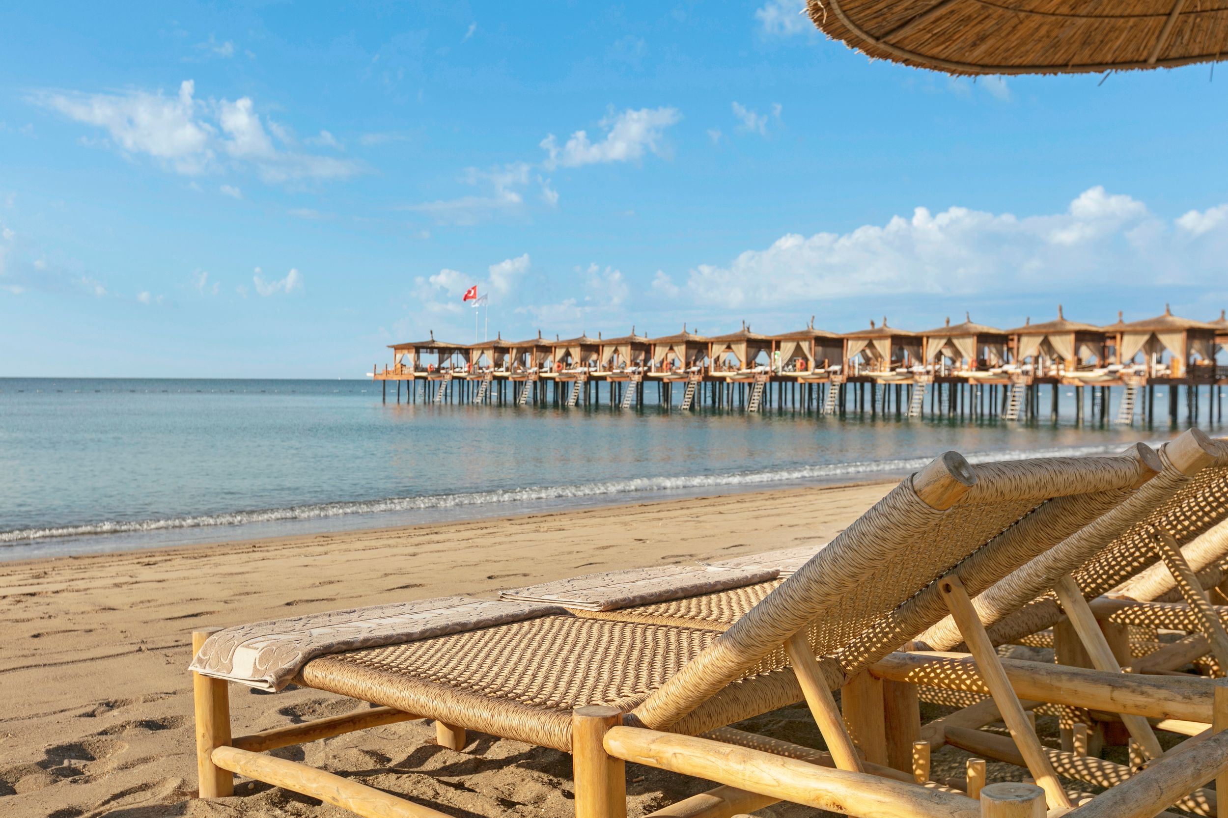 beach loungers in the sea with shore in the foreground