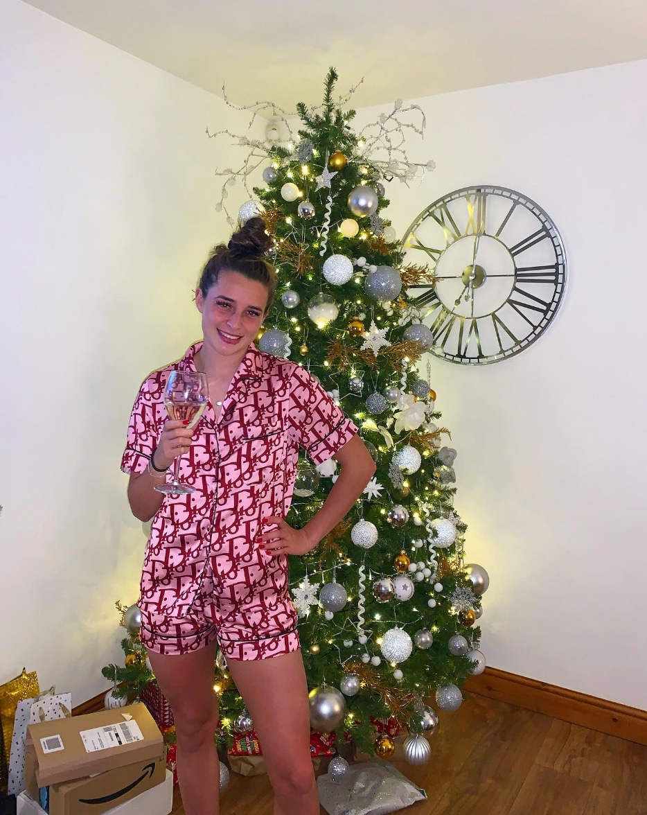 Ella toone in front of Christmas tree