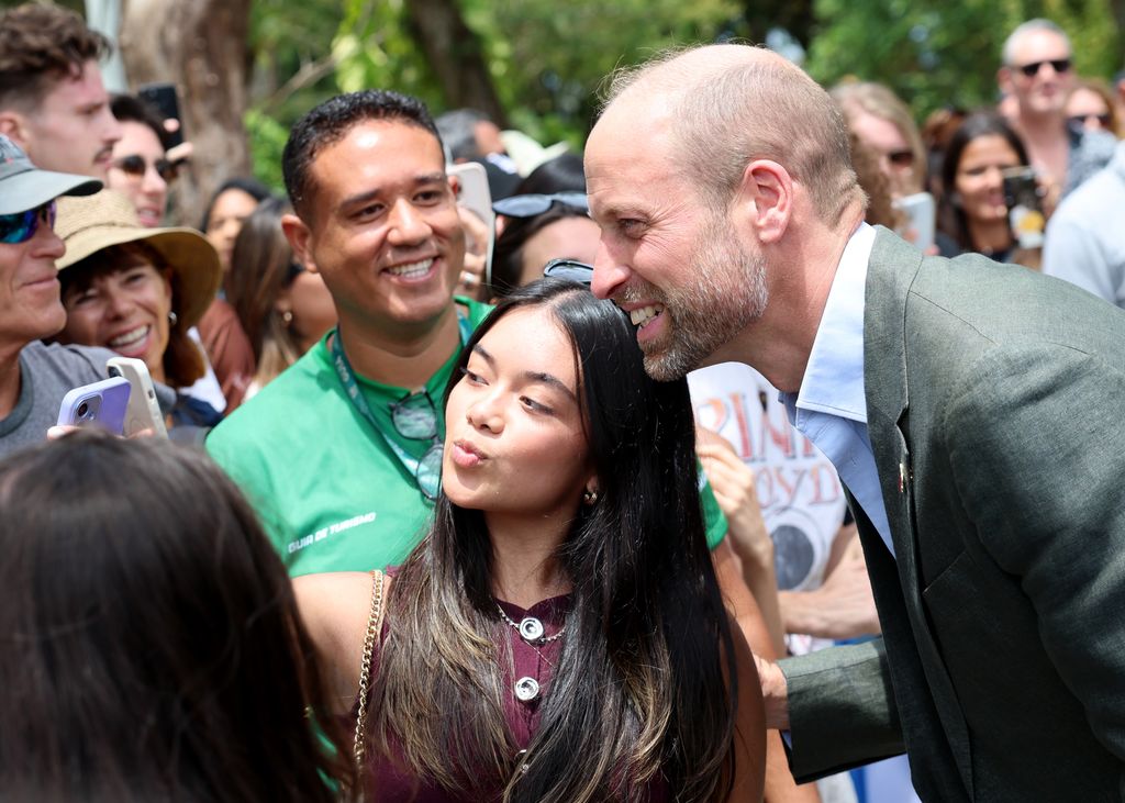 Prince William poses for pictures with members of the public on a visit to Sugarloaf Mountain during day one of his visit to Brazil