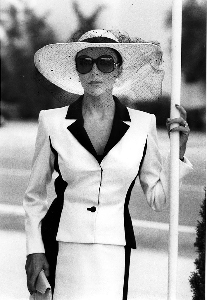 Actress Joan Collins wearing a monochrome Nolan Miller suit as Alexis on the set of Dynasty in 1981