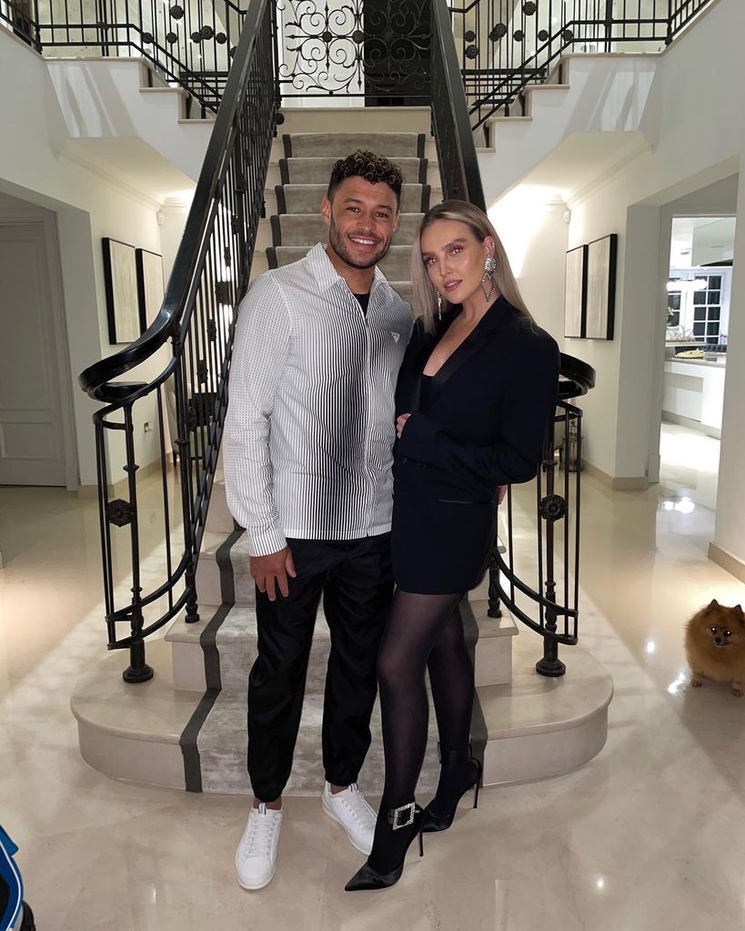 Alex and Perrie in her hallway with stairs behind