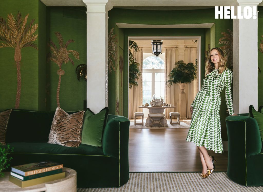 Dee posing in one of the green-toned living rooms in the Palm Beach mansion