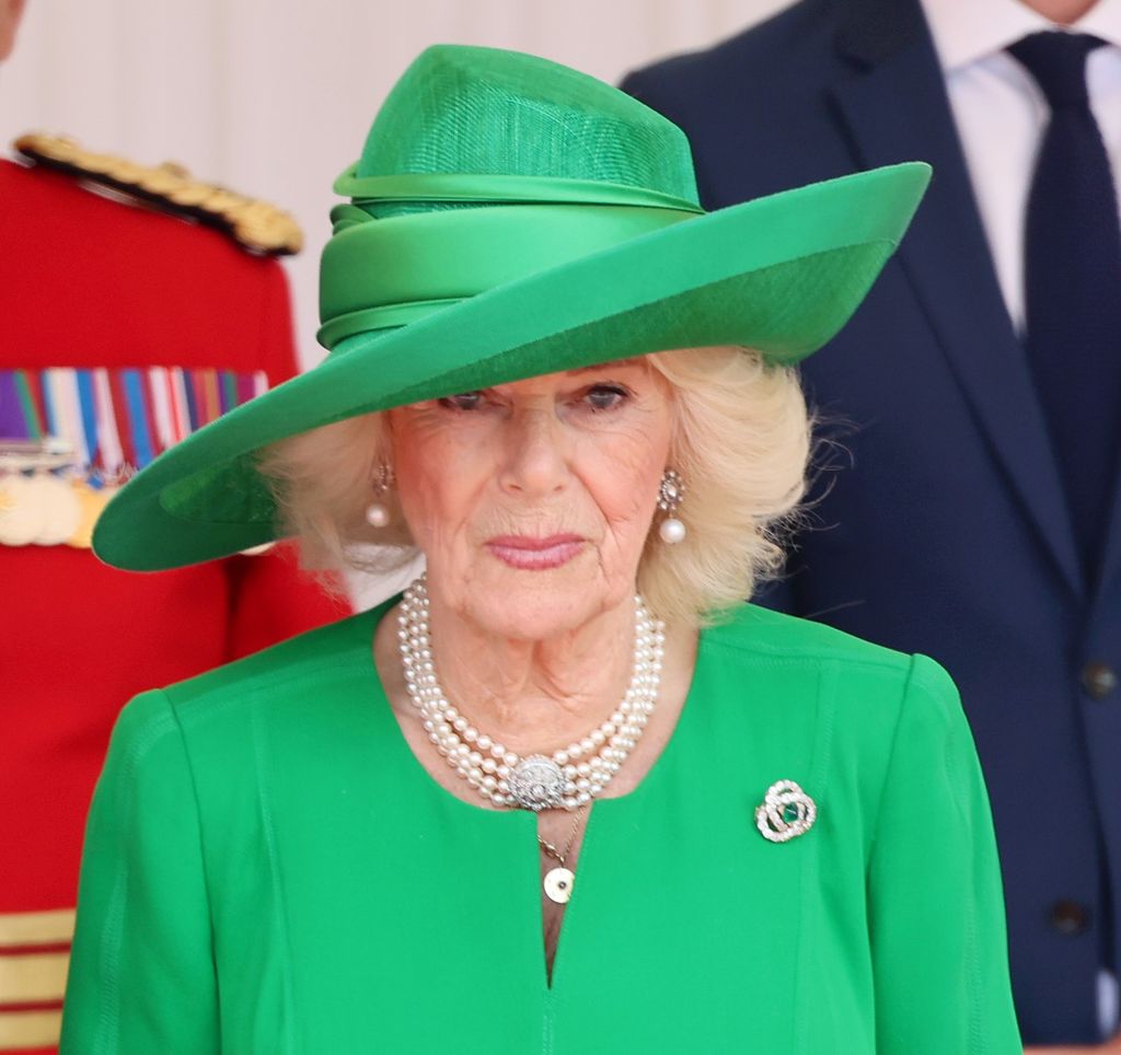 Queen Camilla in green hat and dress 