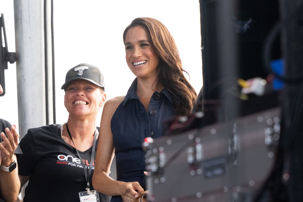 Meghan stunned in a navy shirt dress