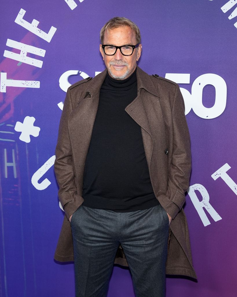 kevin costner with hands in pocket on red carpet