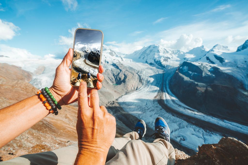 Personal perspective of person photographing Gorner Glacier with smartphone, Switzerland
