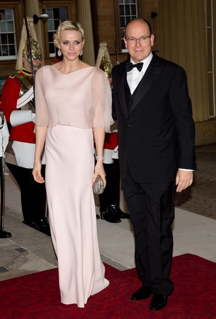 Princess Charlene on red carpet outside palace with prince albert 