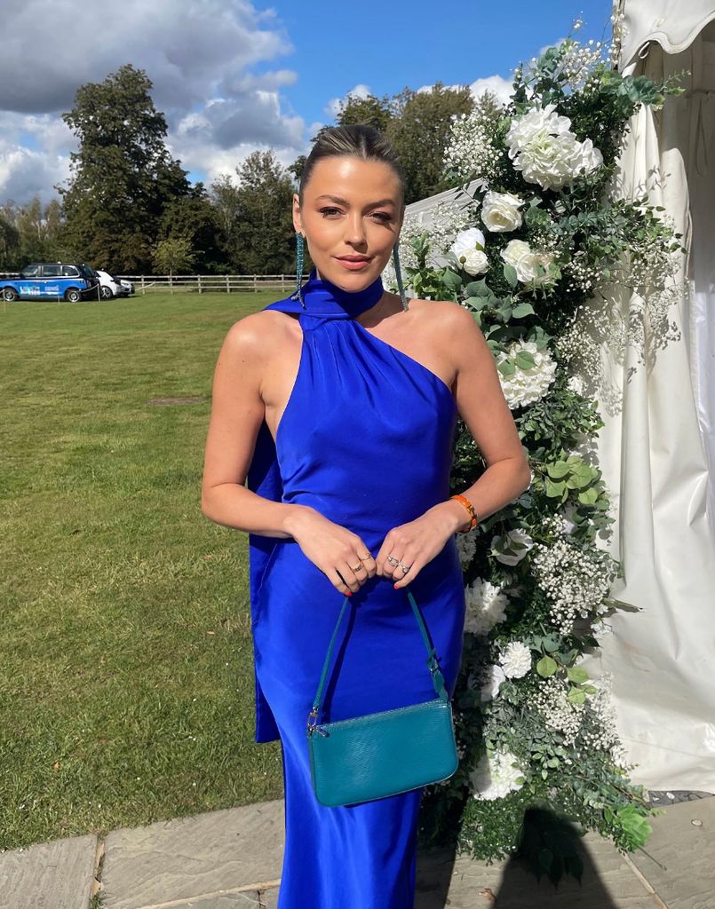 Ellis accessorised the scarf dress she rented from Hurr with a pair of statement crystal earrings which she matched perfectly to the colour of her bag