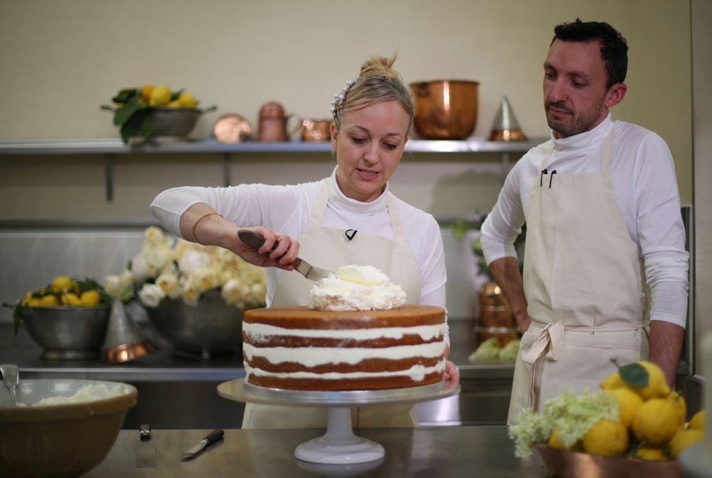 Claire Ptak and head baker Izaak Adams putting the finishing touches on the cake