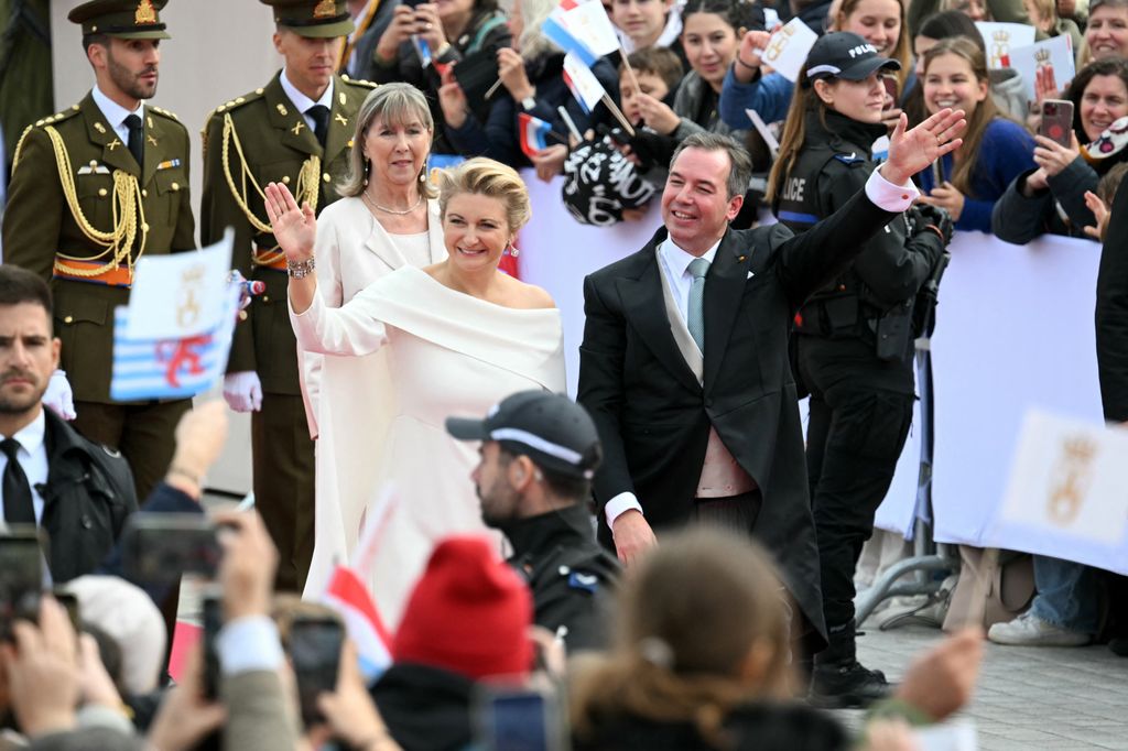 Grand Duke Guillaume and Duchess Stephanie wave to the crowd as they arrive for a solemn session in front of the City Hall
