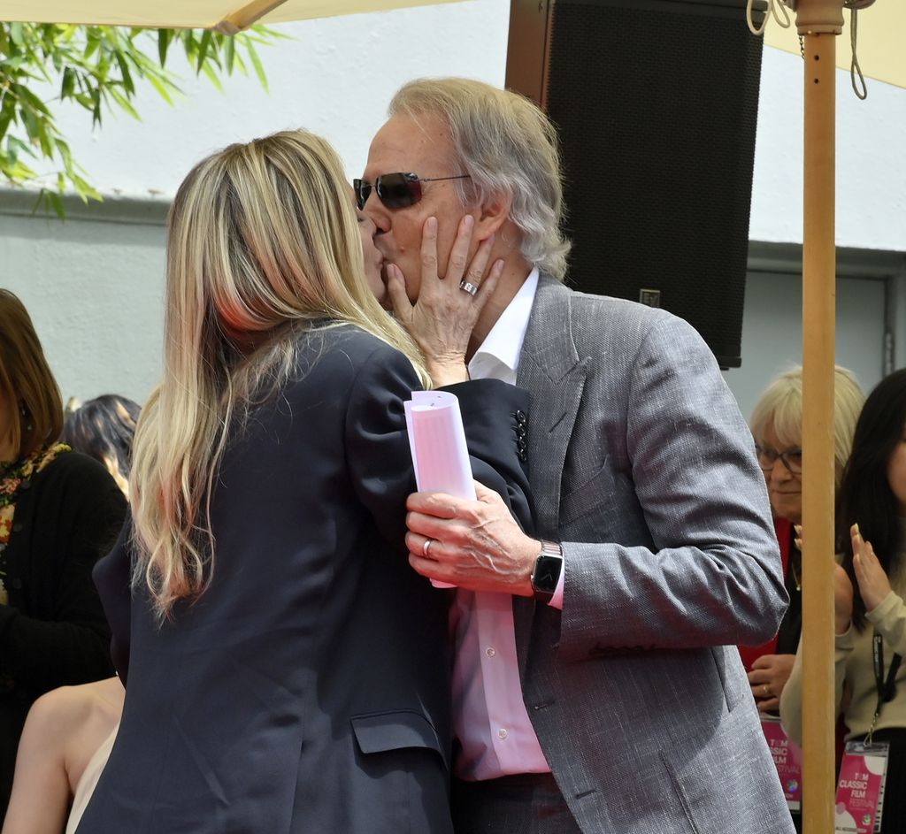 Michelle Pfeiffer is congratulated by her husband David E. Kelley following a hand and footprint ceremony immortalizing Pfeiffer in the forecourt of the TCL Chinese Theatre 
