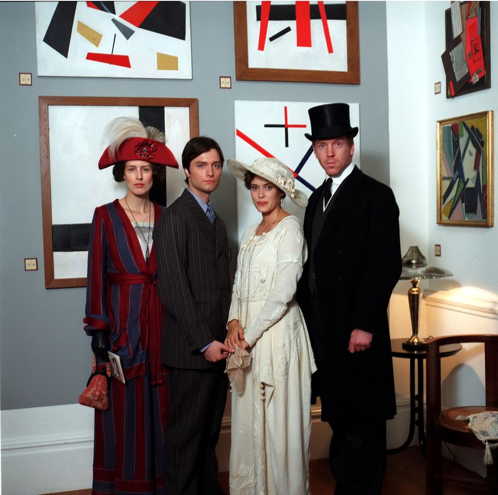 family of four posing in Victorian-era clothing