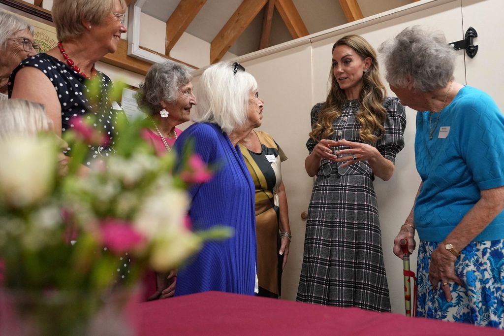 Britain's Catherine, Princess of Wales speaks with members during a visit with Britain's Prince William, Prince of Wales to the National Federation of Women's Institute (WI) in Sunningdale, west of London on September 8, 2025, to commemorate the three-year anniversary of the death of William's late grandmother Queen Elizabeth II. The Prince will meet with members from Sunningdale WI there and across Berkshire to hear about the work of the WI and how it gives opportunities for women to socialise, learn new skills and engage in community projects. (Photo by Alastair Grant / POOL / AFP) (Photo by ALASTAIR GRANT/POOL/AFP via Getty Images)          