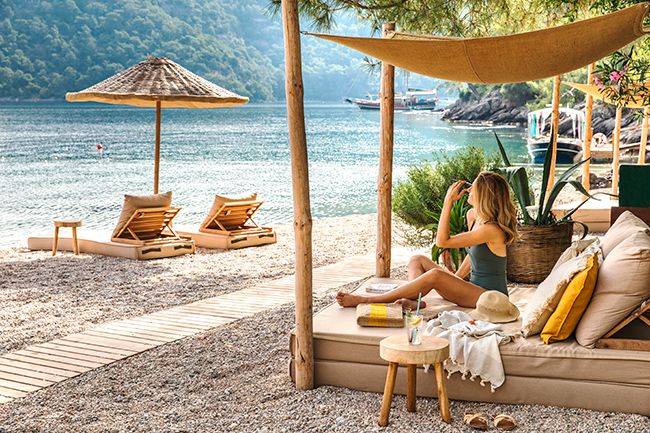Woman sunbathing in swimsuit at Hillside Beach Club private Serenity Beach