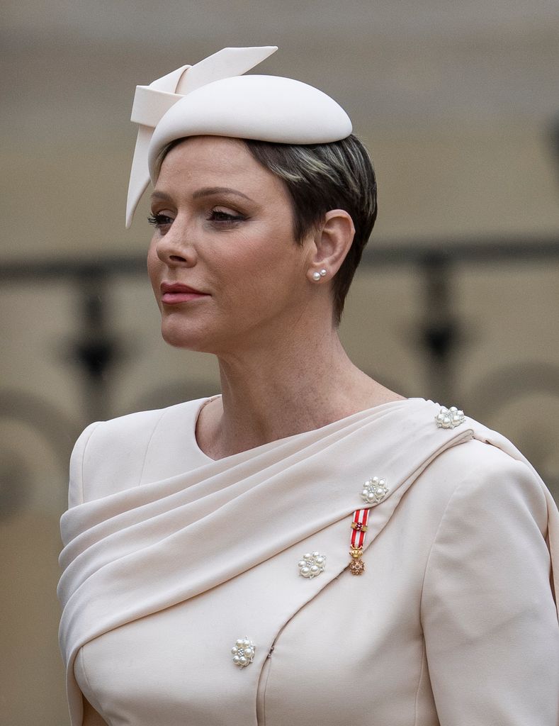 charlene in pink coat dress and button hat 