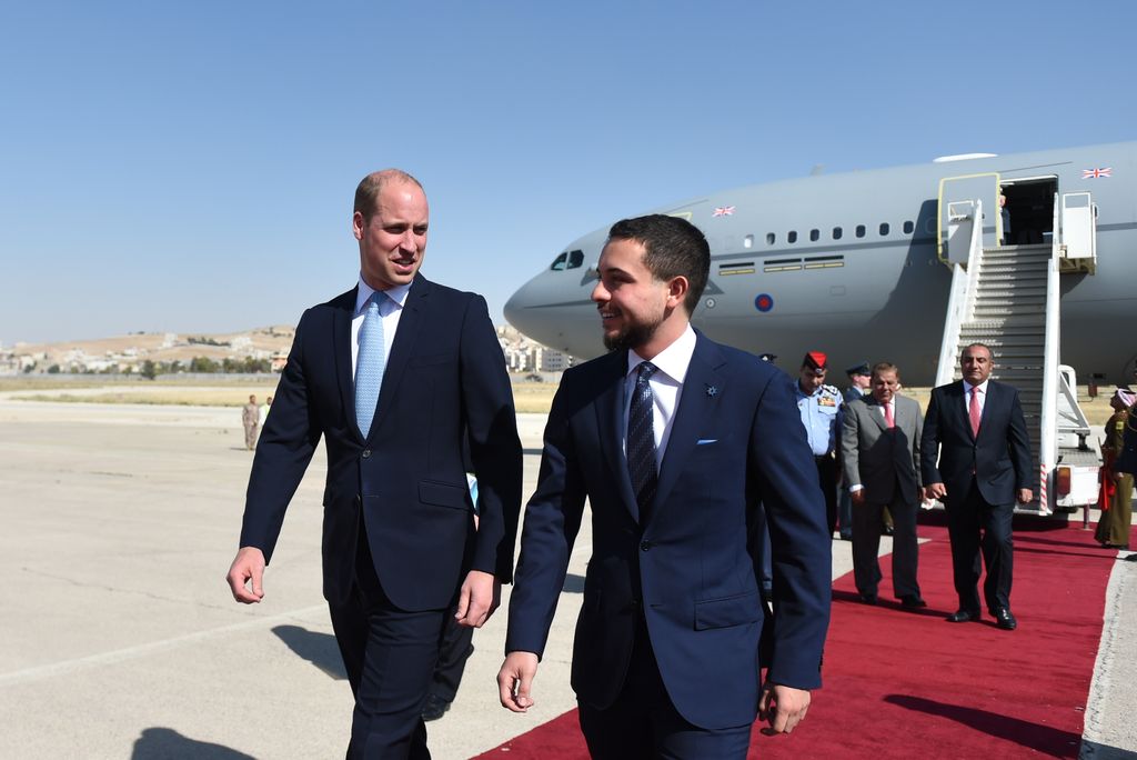 two men in suits walking away from plane 