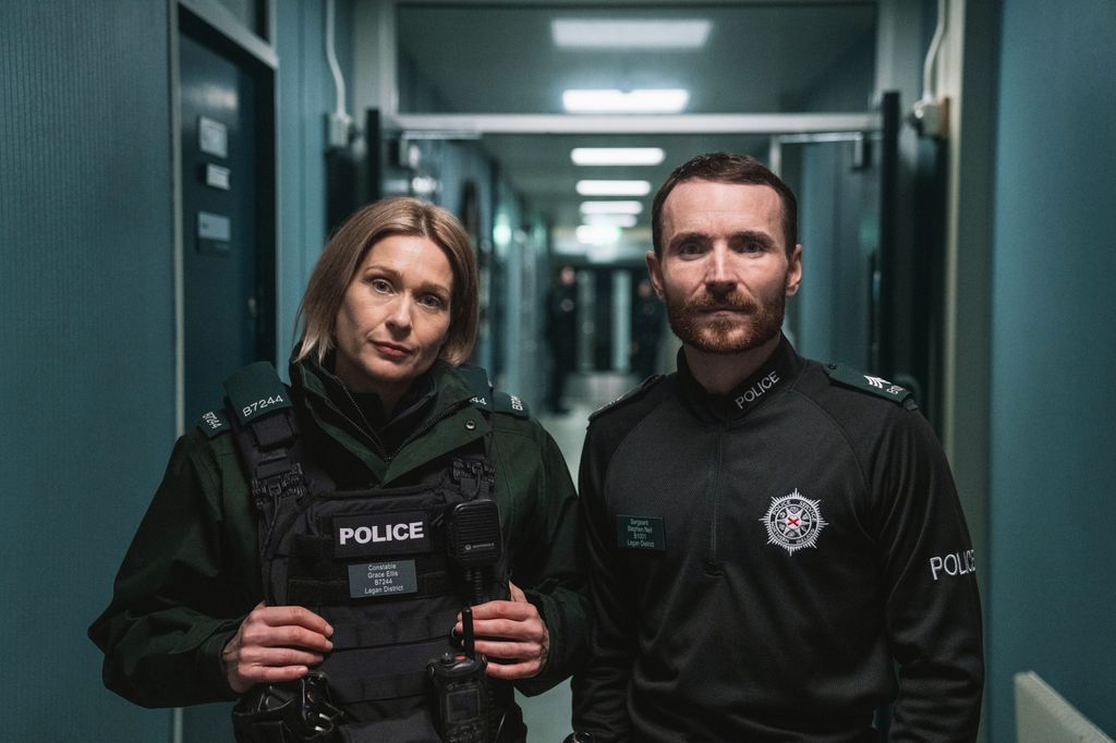 Two police officers stand together
