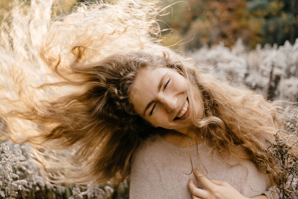 Woman shaking her naturally wavy hair 