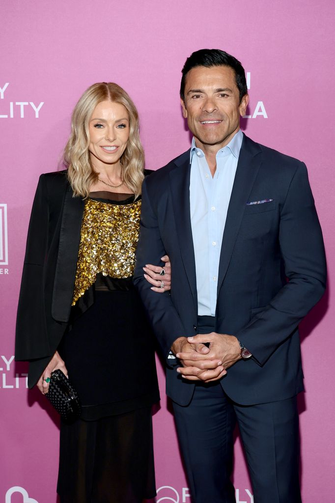 Kelly Ripa in a gold dress and Mark Consuelos in the navy costume to Family Equality's Night