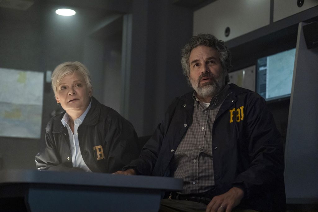 two fbi officers sitting in dimly lit office