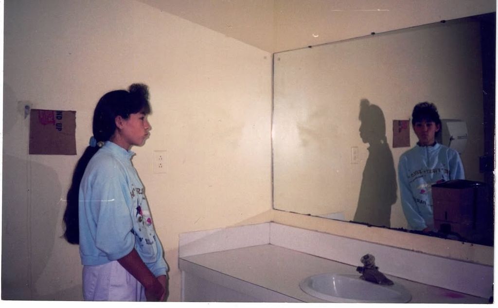 Joanna Gaines poses for a photo staring at her bathroom mirror in a throwback from the '80s, shared on Instagram
