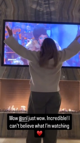 Adele standing in front of her TV and fireplace dancing along to SNL Live concert featuring Lauryn Hill