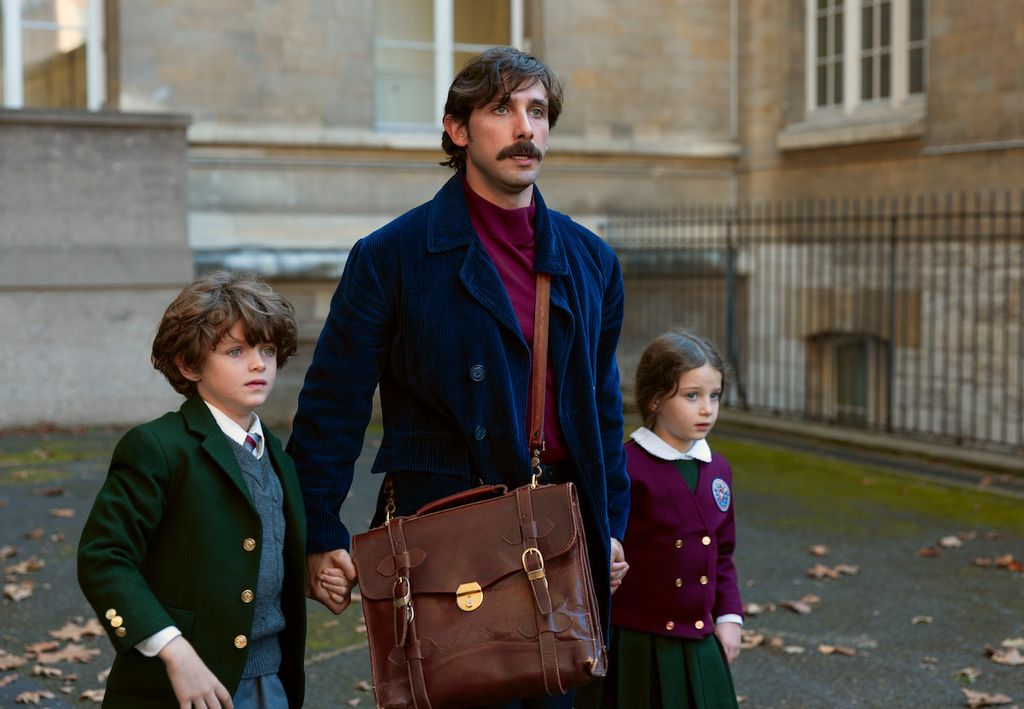 man walking with two young children