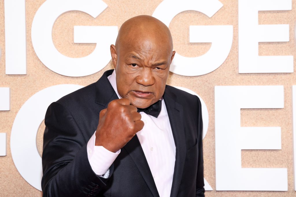 george foreman holding up his fist