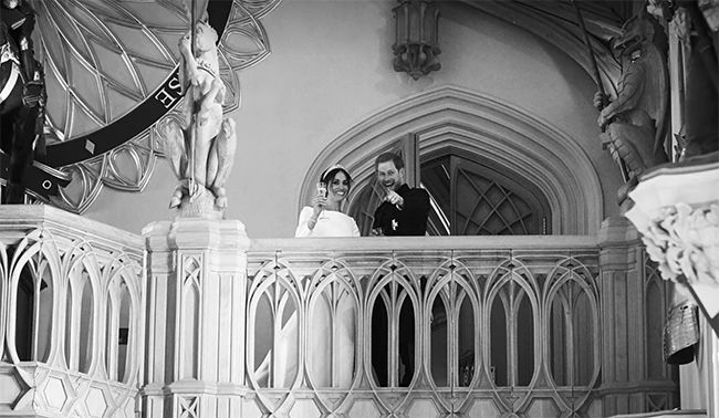 Harry and Meghan raise a toast on the balcony at their wedding reception