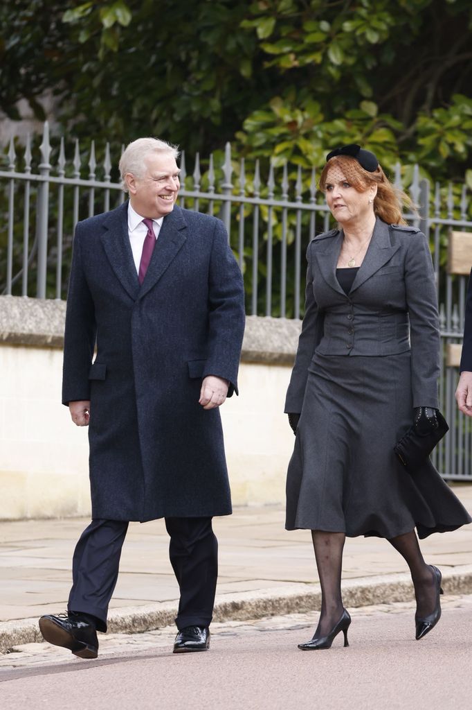 Prince Andrew smiling at Sarah Ferguson who wears a grey skirt suit