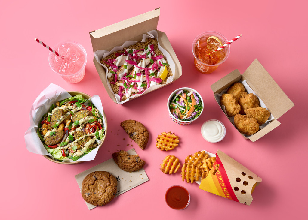 flat lay of boxes of Leon food, waffle fries, cookies and drinks