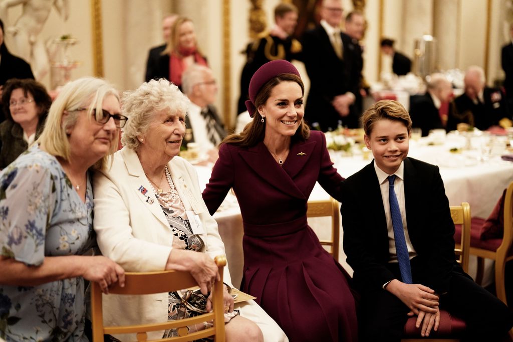 Kate in purple dress with arm around George