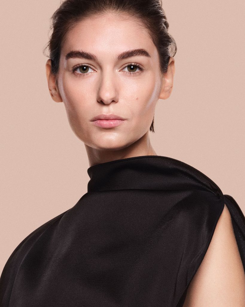Model wearing The Foundation Drops by Victoria Beckham x Augustinus Bader 