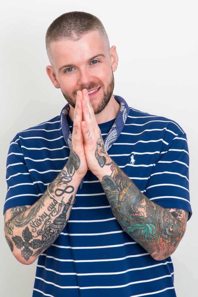 Man in striped T shirt with praying hands